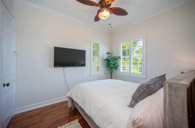 bedroom featuring ceiling fan, ornamental molding, and dark hardwood / wood-style flooring