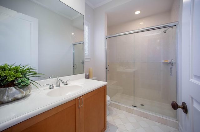 bathroom featuring ornamental molding, vanity, toilet, and a shower with shower door