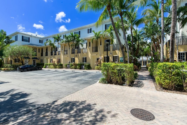 view of property featuring uncovered parking and a residential view