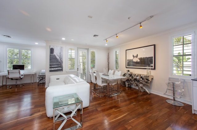 living room featuring crown molding, rail lighting, plenty of natural light, and dark hardwood / wood-style flooring