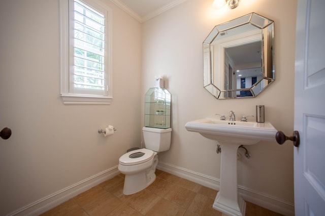 bathroom with ornamental molding and toilet