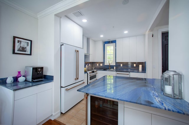 1970 S Dixie Hwy Unit R5, West Palm Beach, FL 33401 - kitchen with visible vents, wine cooler, white cabinetry, backsplash, and premium appliances