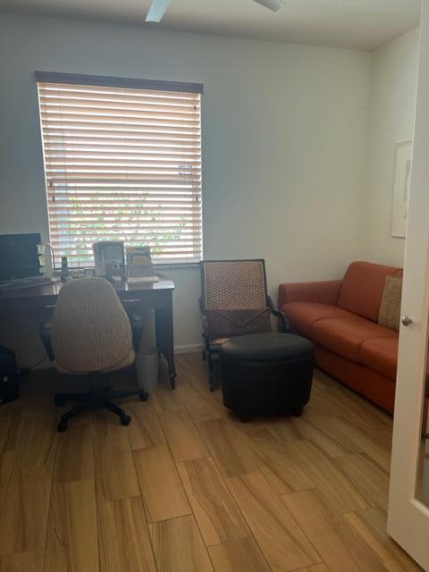 home office with light hardwood / wood-style floors