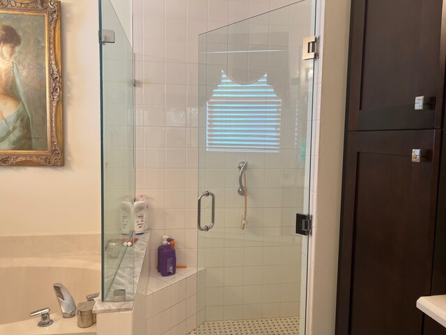 bathroom featuring shower with separate bathtub