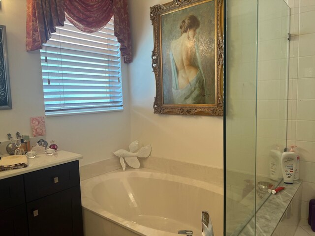 bathroom with vanity and a washtub