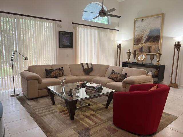 tiled living room featuring ceiling fan