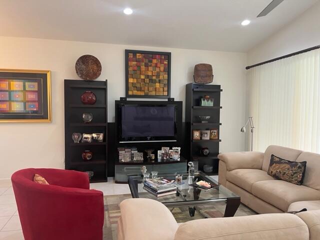 living room with light tile patterned floors and ceiling fan