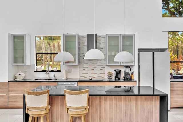 bar with a high ceiling, light tile patterned floors, tasteful backsplash, and sink