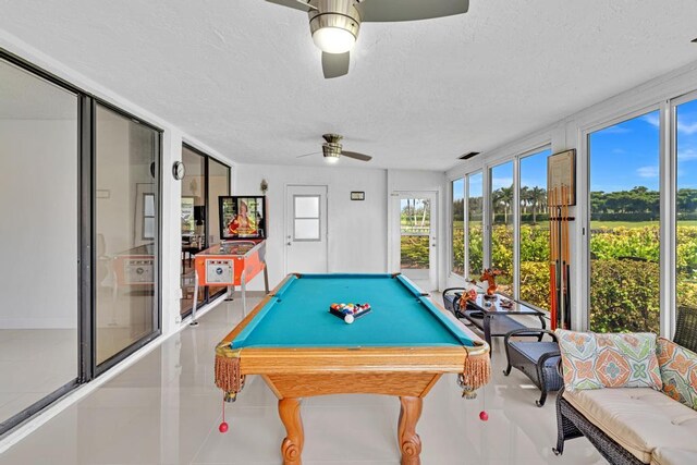 playroom featuring ceiling fan, a textured ceiling, and billiards