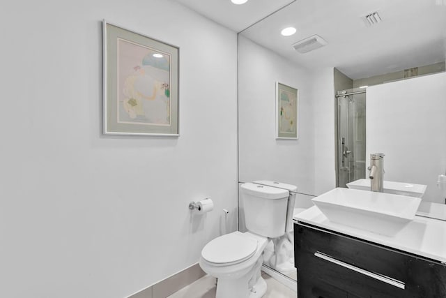 bathroom with vanity, a shower, and toilet