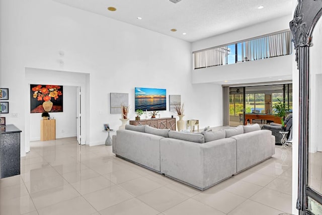 tiled living room featuring a high ceiling