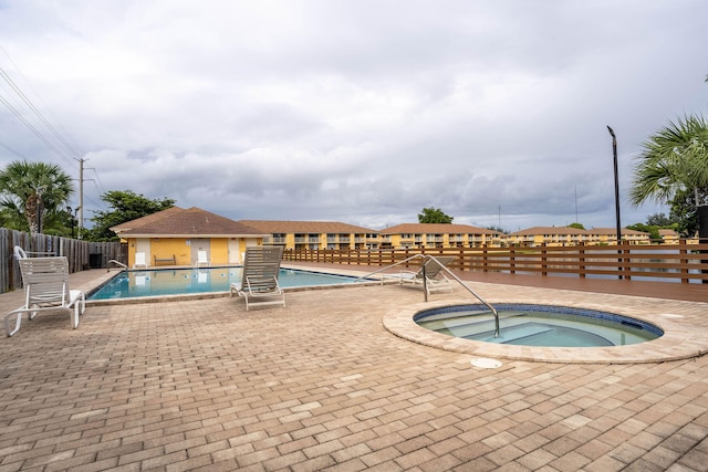 view of pool with a patio area and a community hot tub