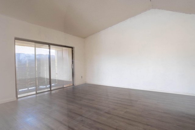 empty room featuring lofted ceiling and dark wood-type flooring