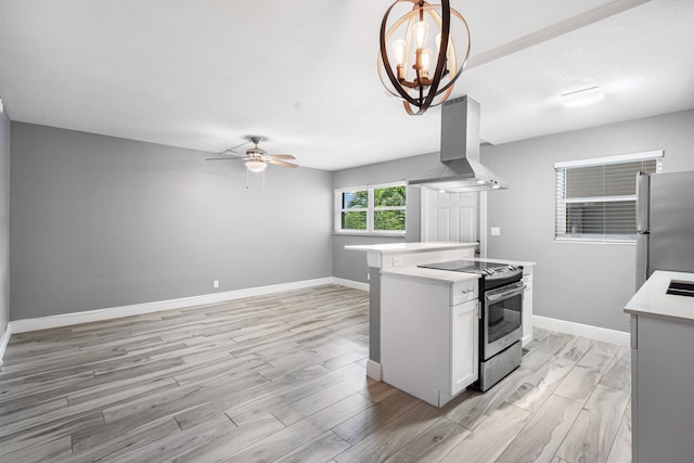 kitchen featuring light hardwood / wood-style floors, white cabinetry, island range hood, pendant lighting, and stainless steel appliances