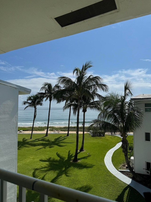 view of yard with a view of the beach and a water view