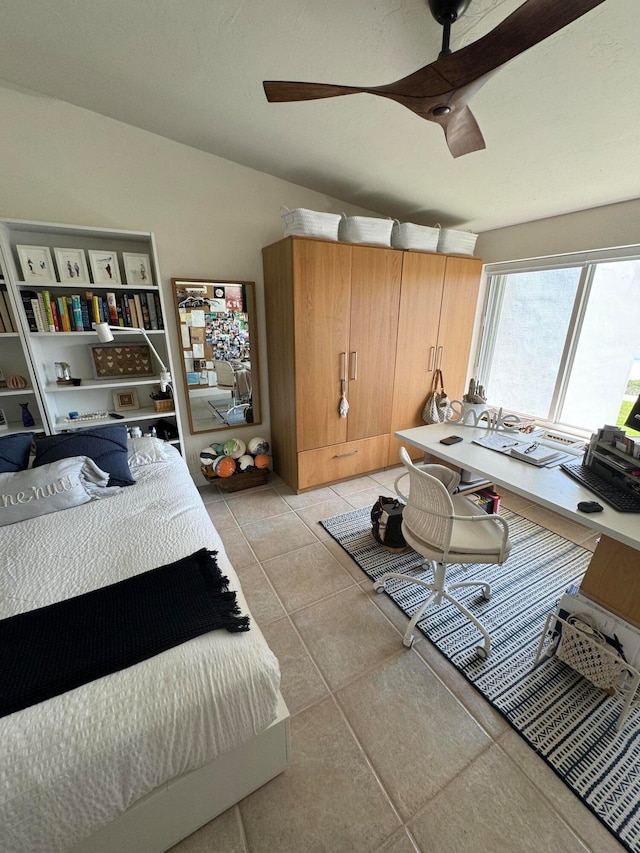 bedroom with ceiling fan and light tile patterned floors