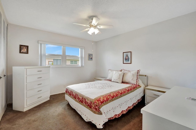 carpeted bedroom with ceiling fan and a textured ceiling