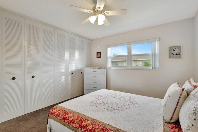 carpeted bedroom featuring ceiling fan and a closet