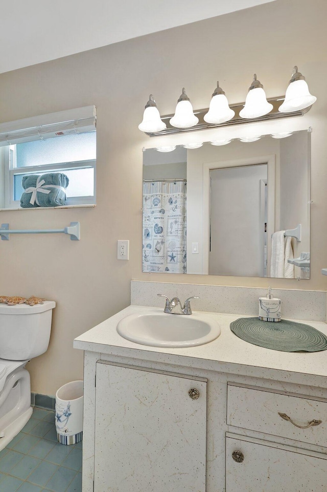 bathroom featuring tile patterned flooring, vanity, and toilet