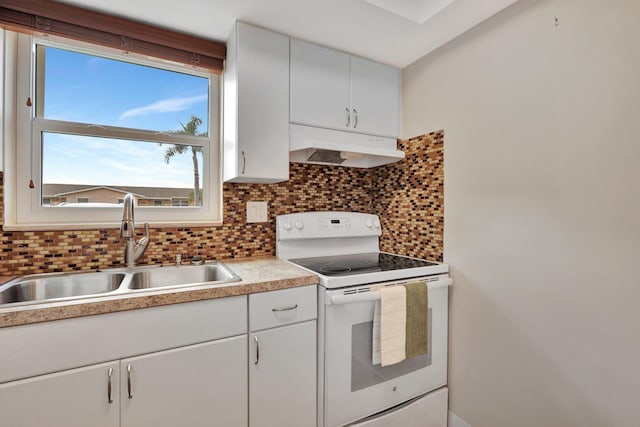 kitchen with sink, backsplash, white electric stove, and white cabinetry