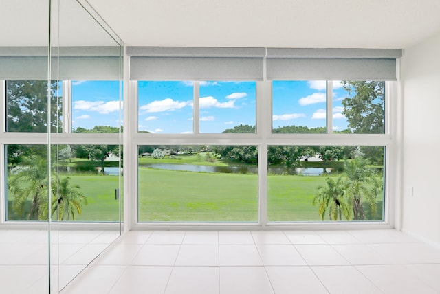 unfurnished sunroom with a water view