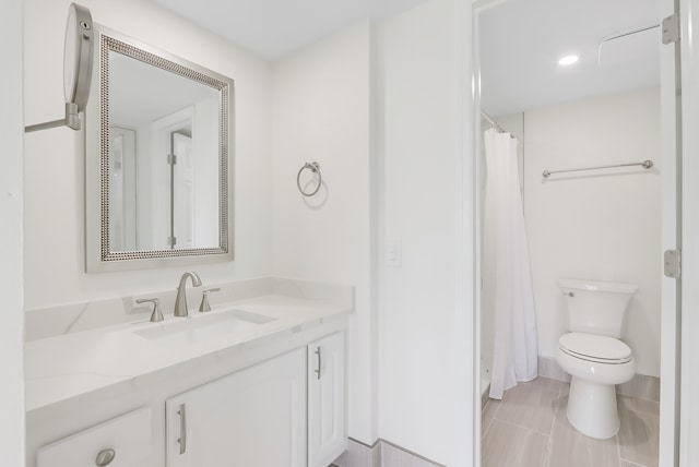 bathroom with vanity, toilet, curtained shower, and tile patterned floors