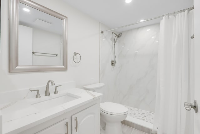 bathroom with toilet, a marble finish shower, and vanity