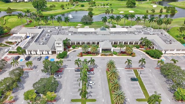 birds eye view of property featuring view of golf course and a water view