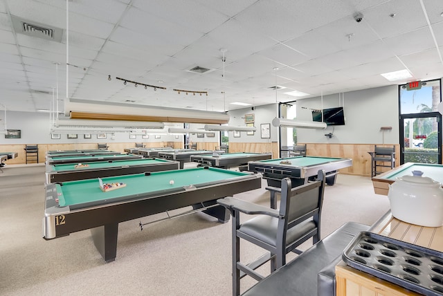 playroom with a paneled ceiling, pool table, and wooden walls