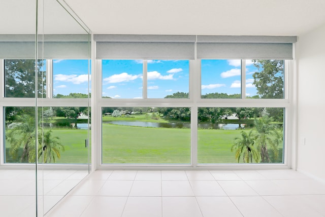 unfurnished sunroom featuring a wealth of natural light and a water view