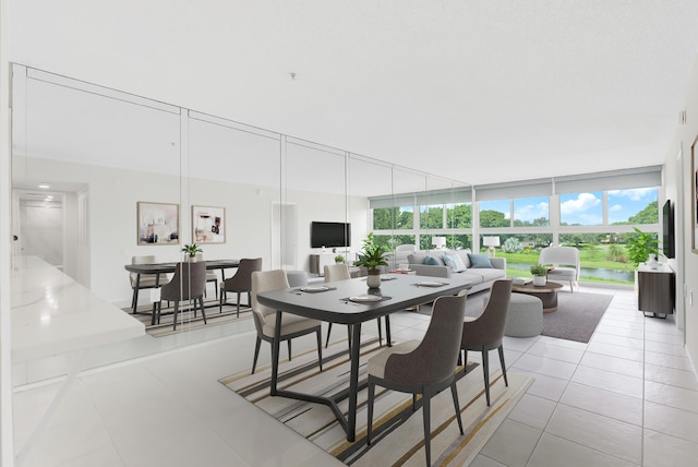 dining space featuring light tile patterned floors and expansive windows