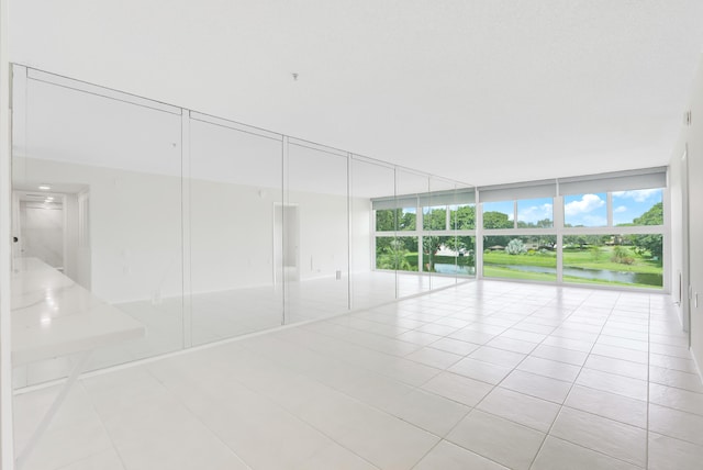 empty room featuring light tile patterned floors and expansive windows