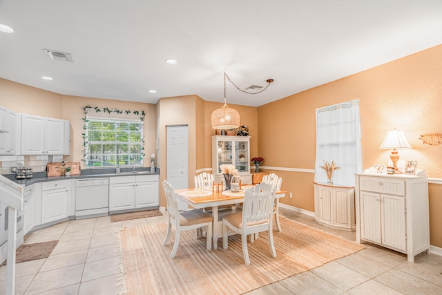 dining room with light tile patterned flooring and sink