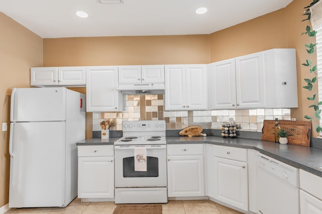 kitchen with backsplash, white appliances, and white cabinetry