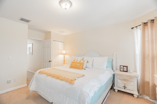 carpeted bedroom featuring a closet