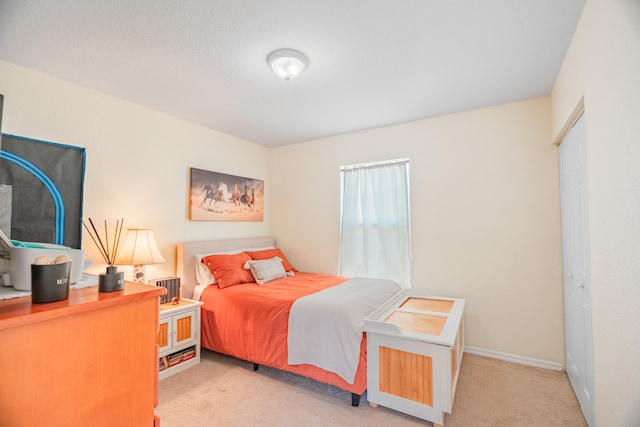 bedroom featuring light carpet