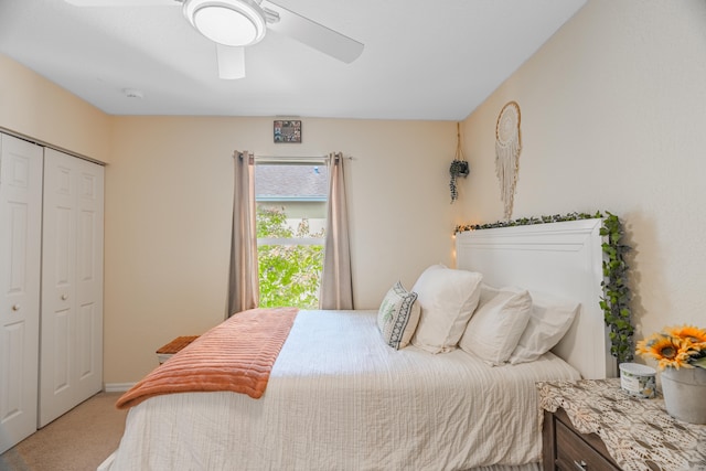 carpeted bedroom with ceiling fan and a closet