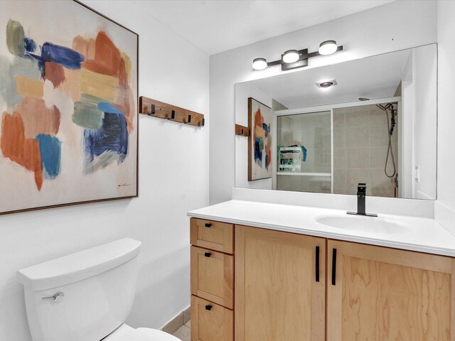 bathroom with tile patterned floors, wood walls, vanity, and toilet