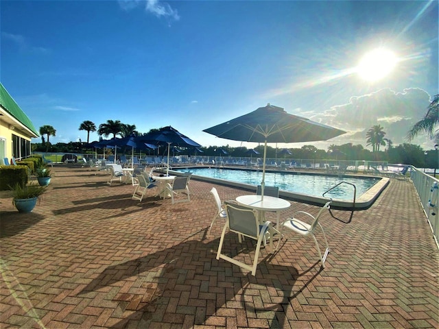 view of pool featuring a mountain view and a patio