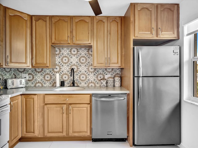 kitchen featuring decorative backsplash, sink, and appliances with stainless steel finishes