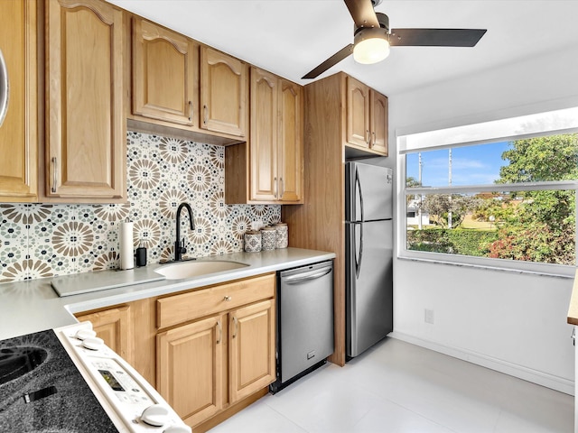 kitchen with decorative backsplash, appliances with stainless steel finishes, ceiling fan, and sink