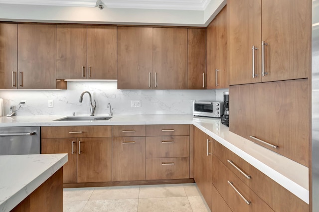 kitchen with sink, dishwasher, light tile patterned floors, decorative backsplash, and crown molding