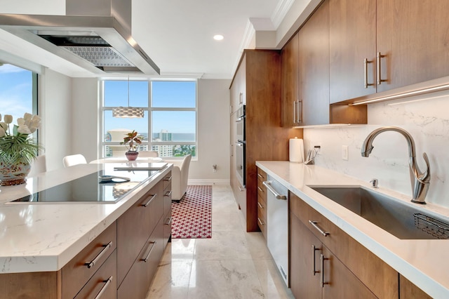 kitchen with stainless steel appliances, crown molding, sink, wall chimney range hood, and backsplash