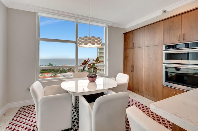 dining space featuring ornamental molding, a water view, and plenty of natural light