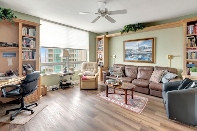 living room featuring light wood-type flooring and ceiling fan