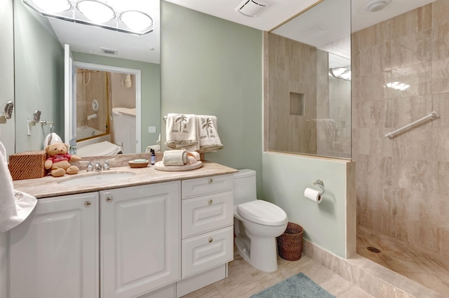 full bathroom with toilet, tiled shower / bath combo, tile patterned floors, and vanity