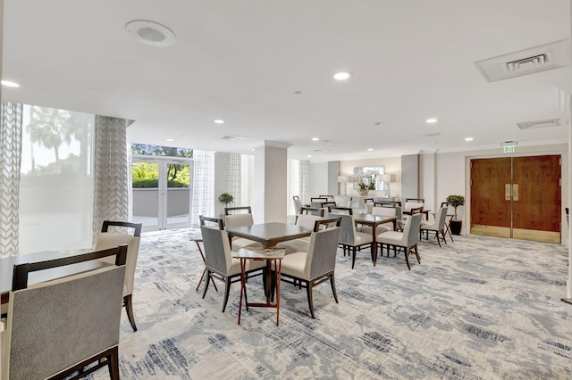 carpeted dining room featuring french doors