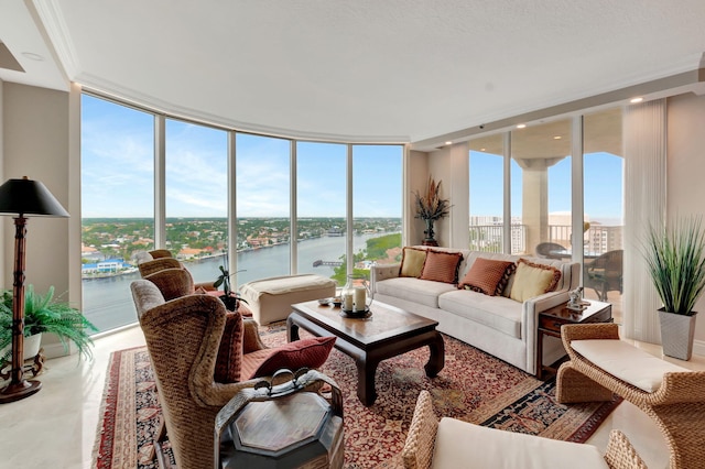 sunroom featuring a water view and a wealth of natural light