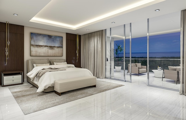 bedroom featuring access to exterior and a tray ceiling