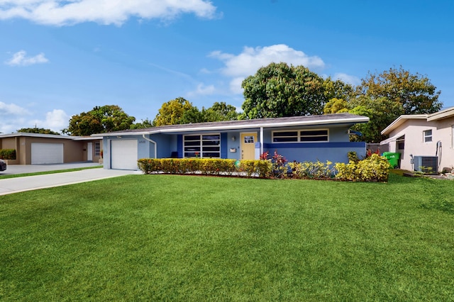 single story home with a front lawn, a garage, and central AC